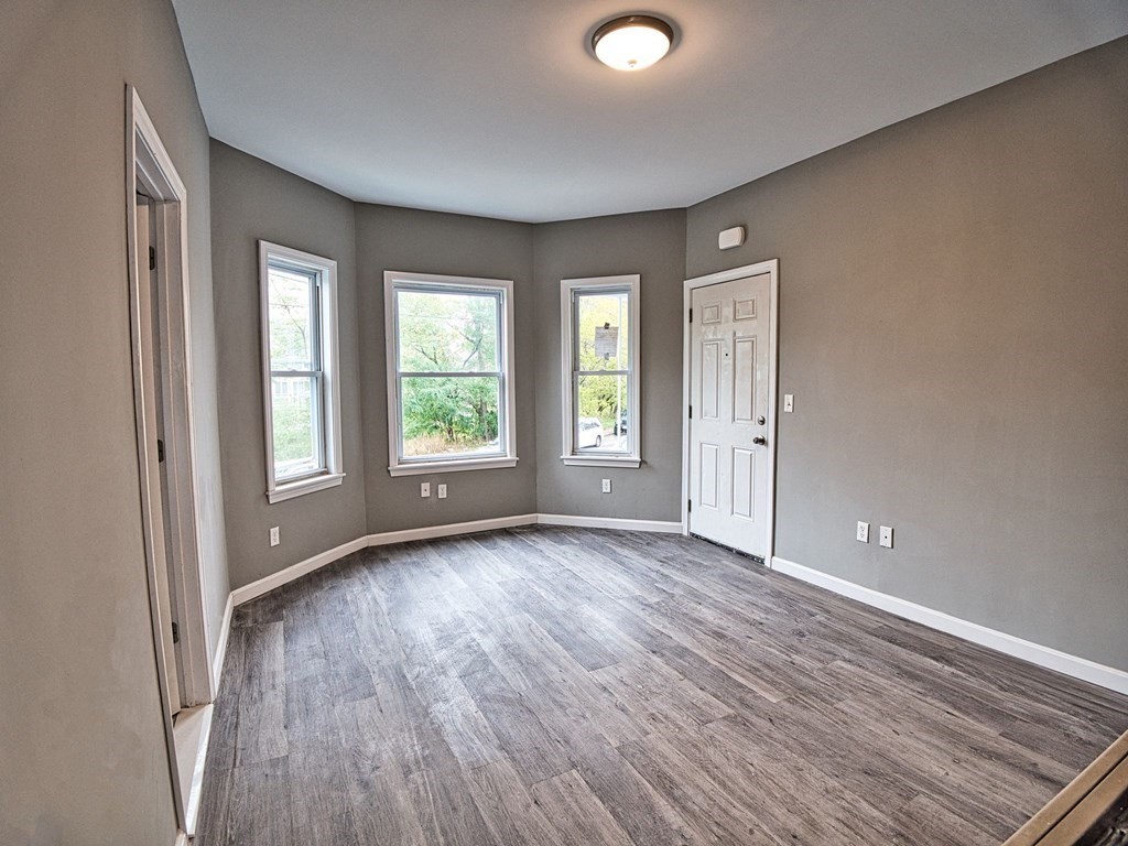 62 Bay Street Fall River, MA 02721 - Photo 4 of 21 a view of an empty room with wooden floor and a window