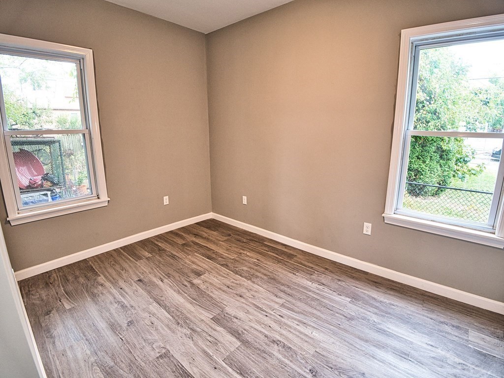 62 Bay Street Fall River, MA 02721 - Photo 10 of 21 a view of empty room with wooden floor and fan
