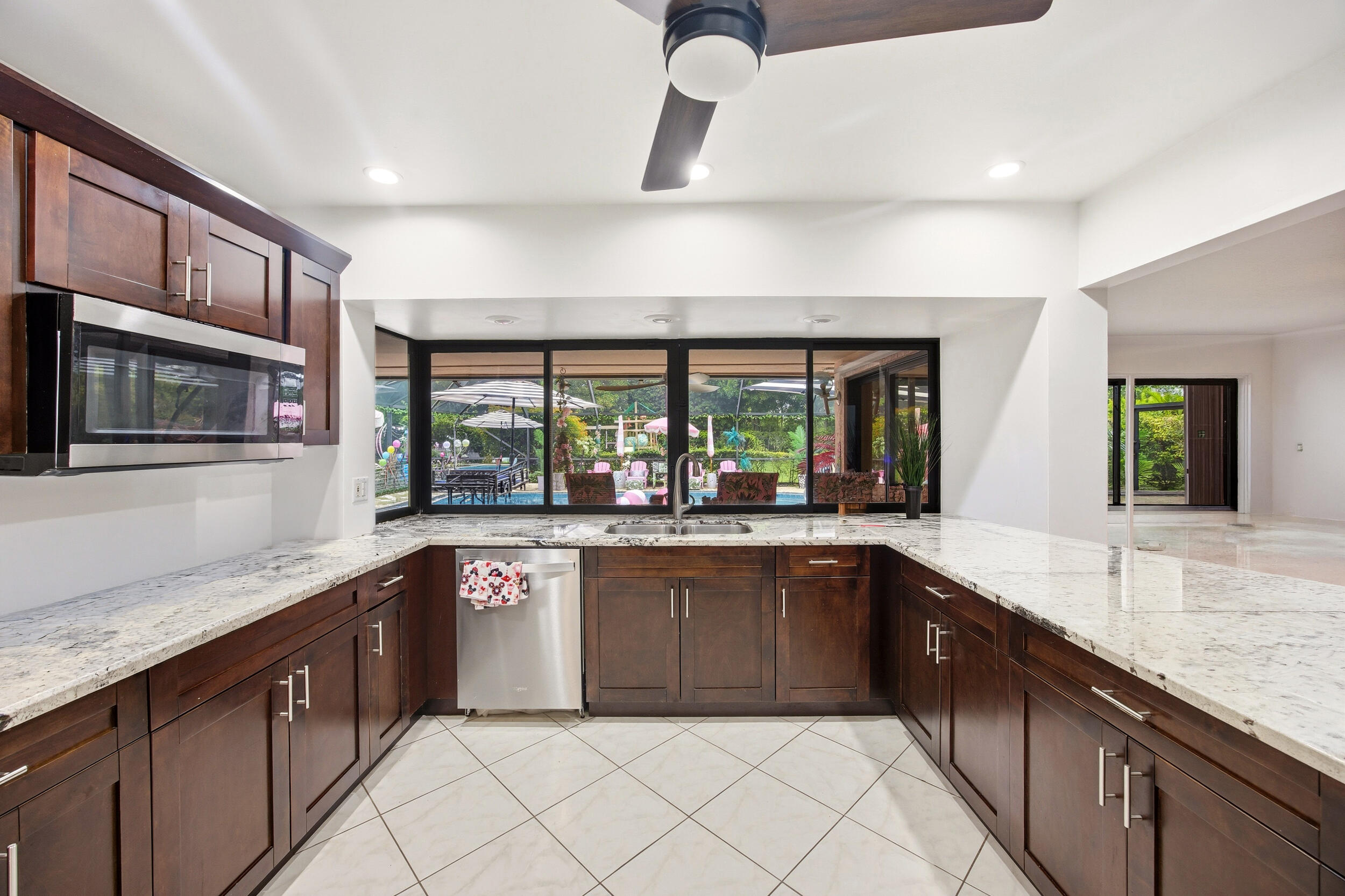 375 Northwest 53rd Street Boca Raton, FL 33487 - Photo 8 of 14 a large kitchen with stainless steel appliances granite countertop a sink and cabinets