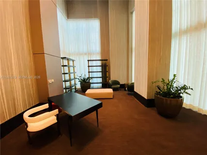 a room with pool table and large windows