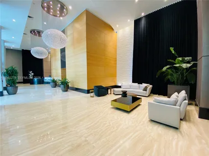 a room with pool table and chairs