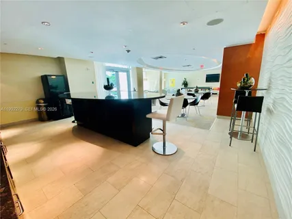 a room with lots of chairs and potted plant