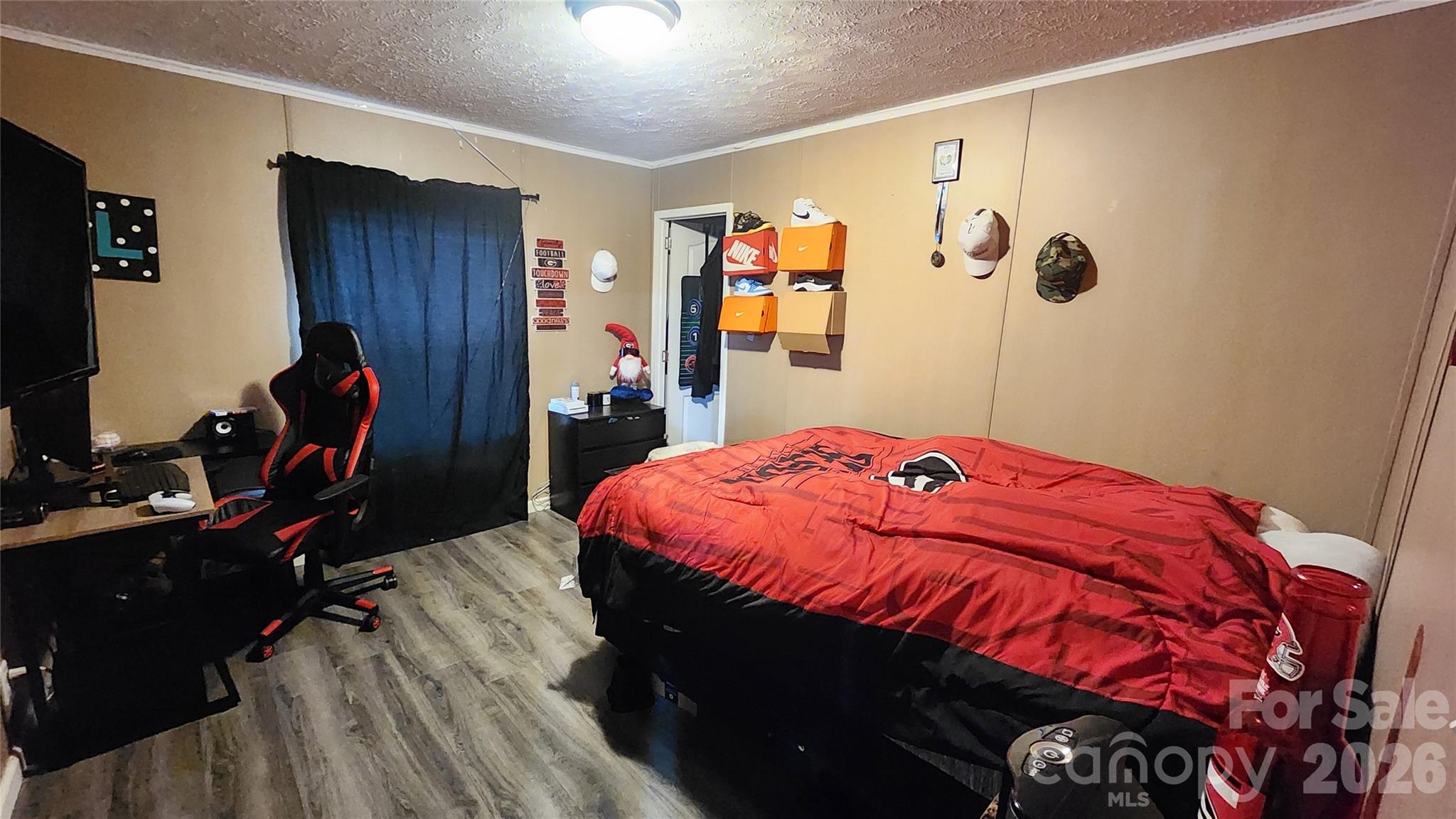 67 Indian Trail Road Candler, NC 28715 - Photo 13 of 31 a bed sitting in a bedroom next to a window