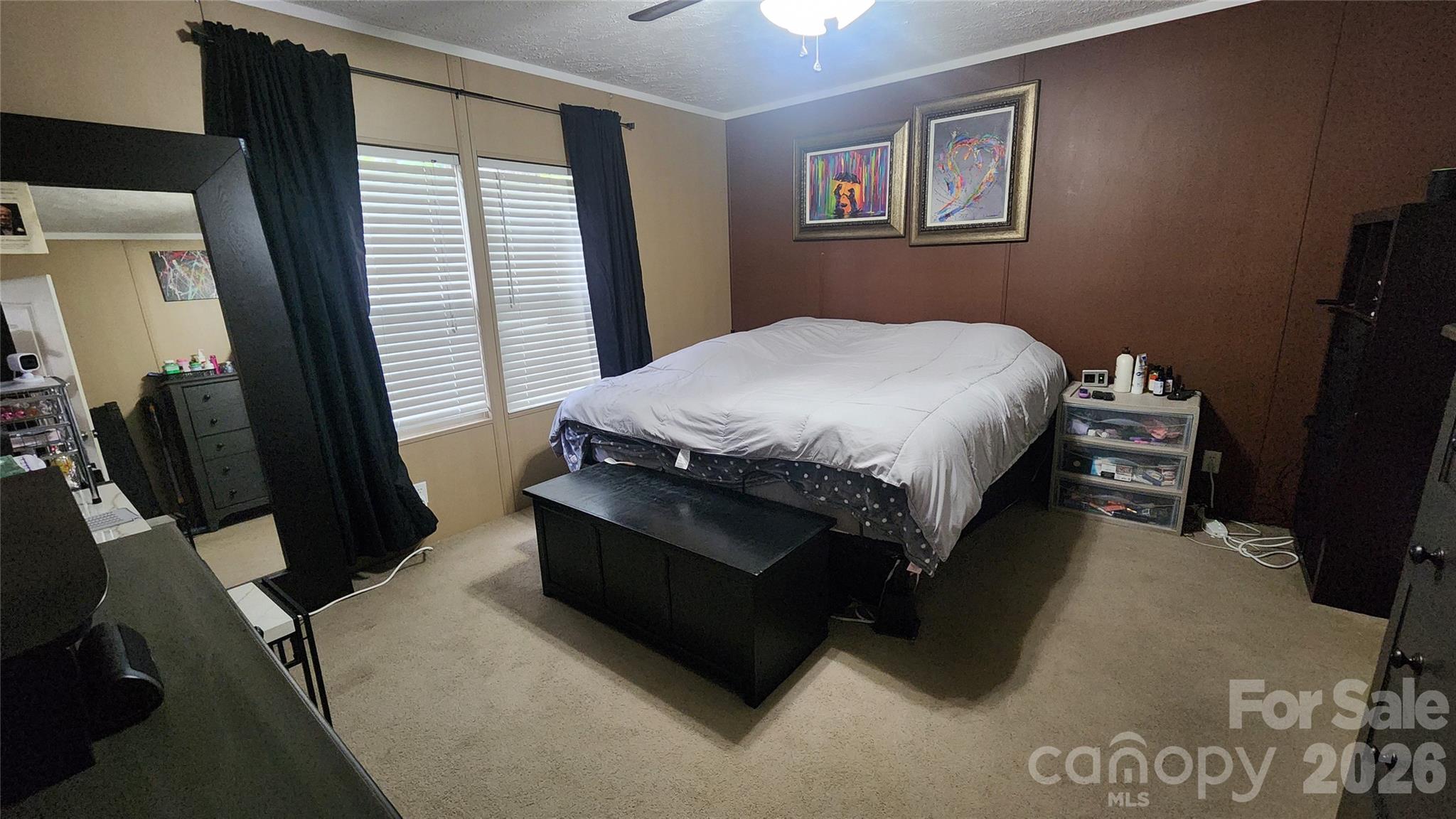 67 Indian Trail Road Candler, NC 28715 - Photo 16 of 31 a bed sitting in a bedroom next to a window