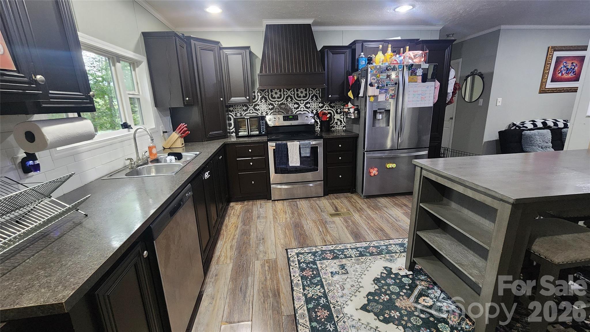 67 Indian Trail Road Candler, NC 28715 - Photo 17 of 31 a kitchen with stainless steel appliances granite countertop a sink stove and refrigerator