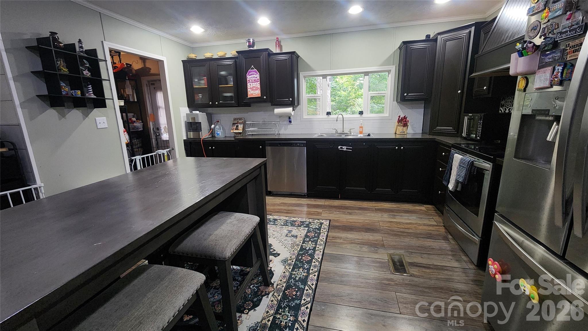 67 Indian Trail Road Candler, NC 28715 - Photo 21 of 31 a kitchen with stainless steel appliances a sink stove and refrigerator