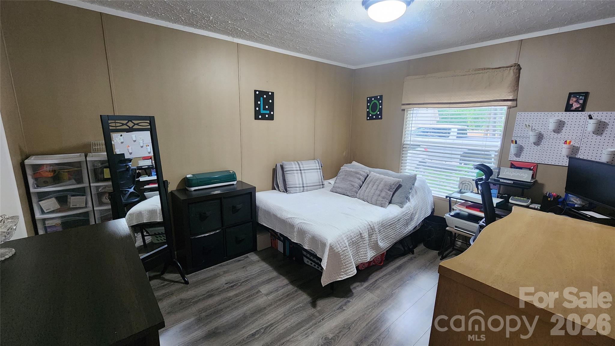 67 Indian Trail Road Candler, NC 28715 - Photo 22 of 31 a bedroom with a bed and wooden floor
