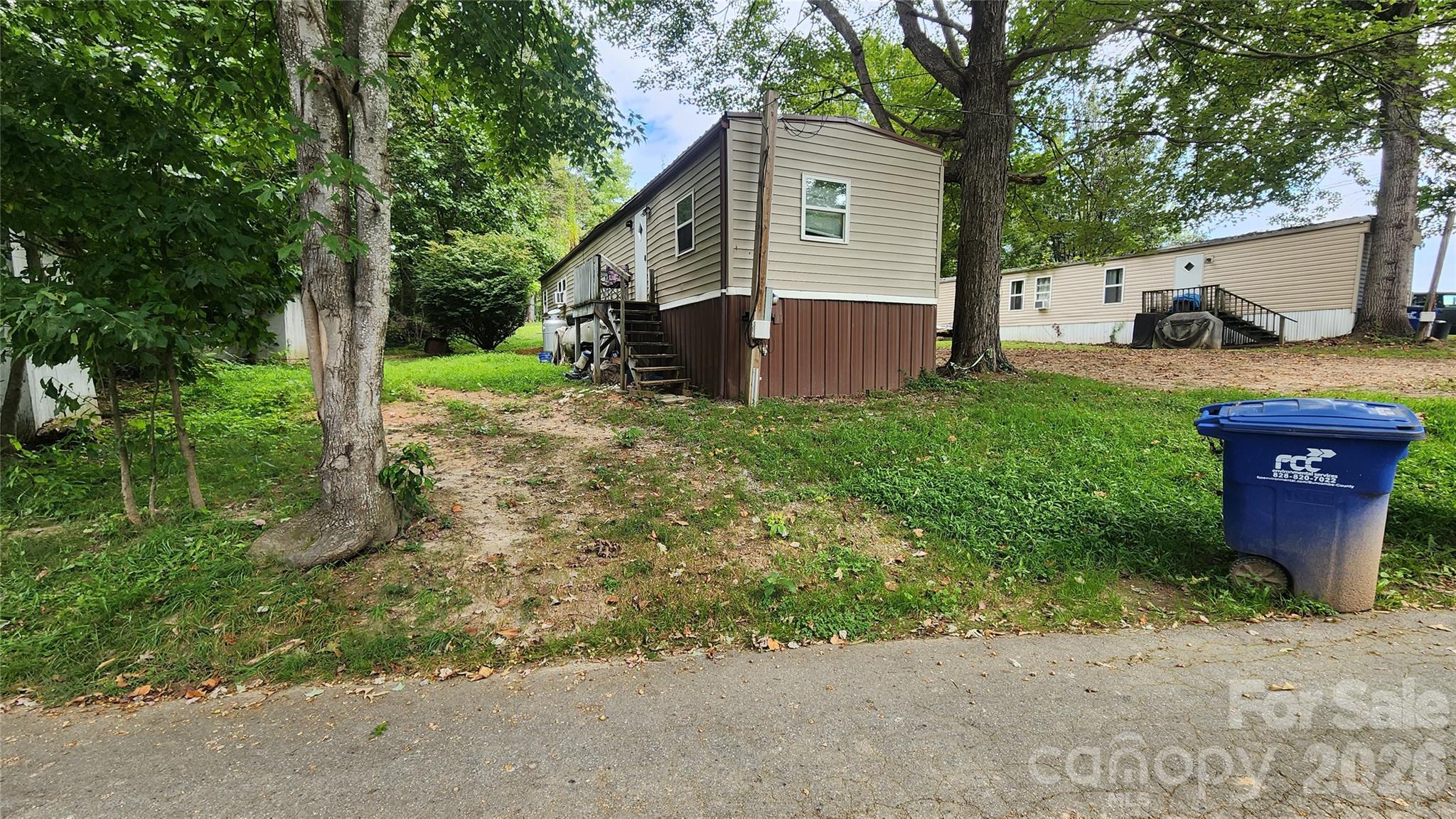 67 Indian Trail Road Candler, NC 28715 - Photo 25 of 31 a view of a house with a yard and tree s