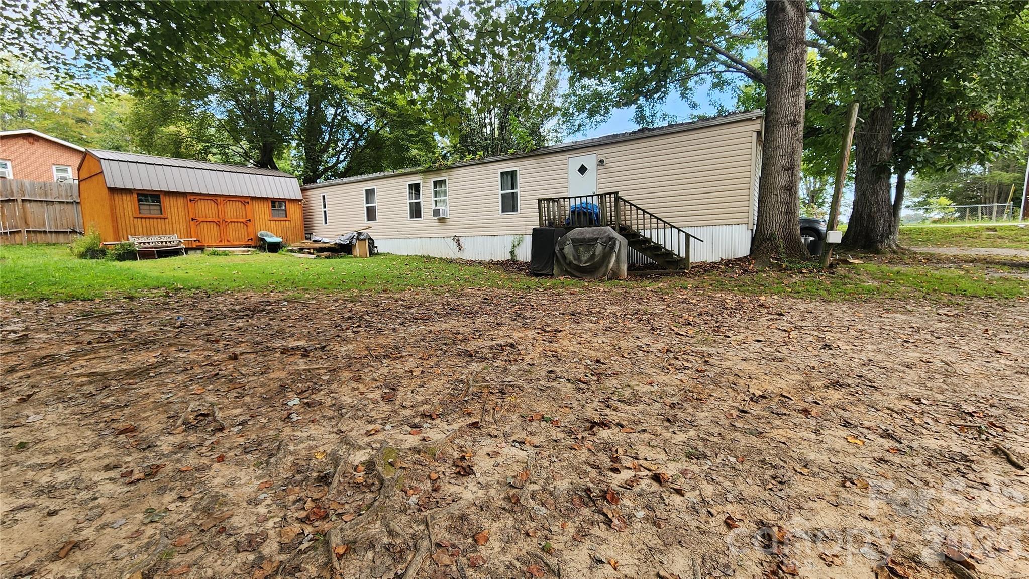 67 Indian Trail Road Candler, NC 28715 - Photo 27 of 31 a view of a house with backyard