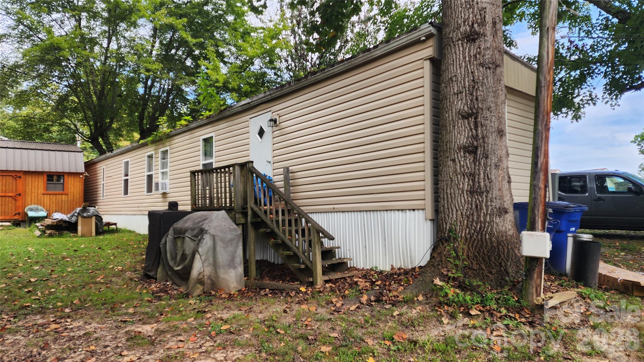 67 Indian Trail Road Candler, NC 28715 - Photo 28 of 31 a house view with a backyard space and garden