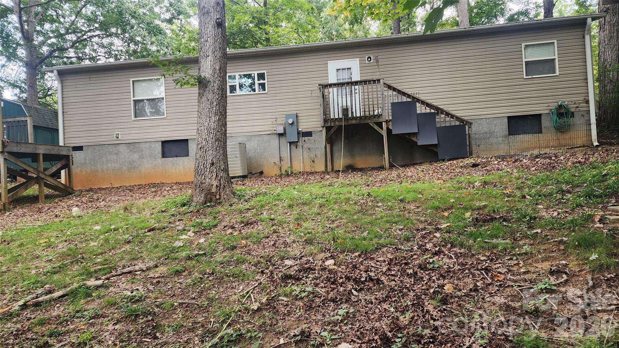 67 Indian Trail Road Candler, NC 28715 - Photo 5 of 31 a backyard of a house with table and chairs