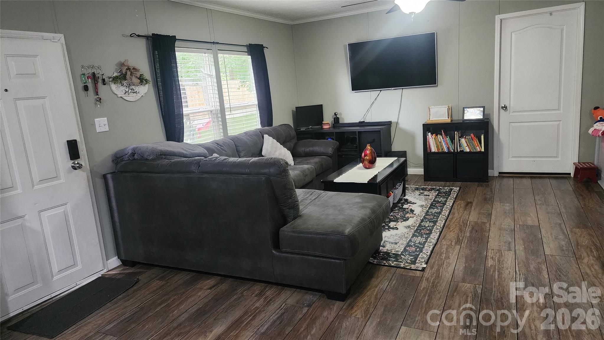 67 Indian Trail Road Candler, NC 28715 - Photo 8 of 31 a living room with furniture and a flat screen tv