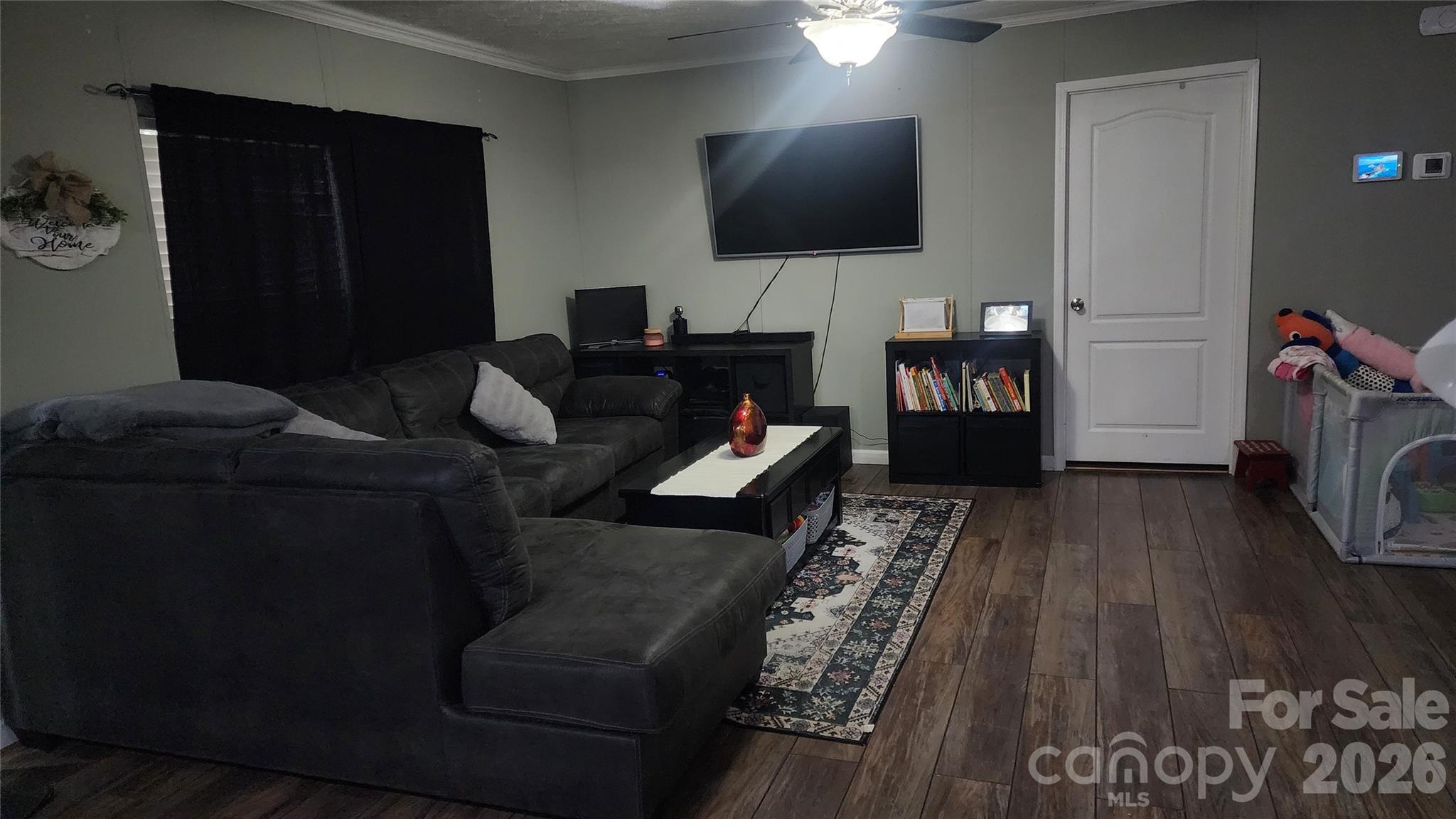 67 Indian Trail Road Candler, NC 28715 - Photo 9 of 31 a living room with furniture and a flat screen tv