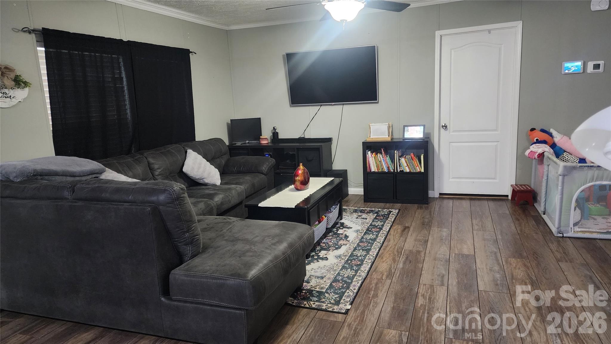 67 Indian Trail Road Candler, NC 28715 - Photo 10 of 31 a living room with furniture and a flat screen tv