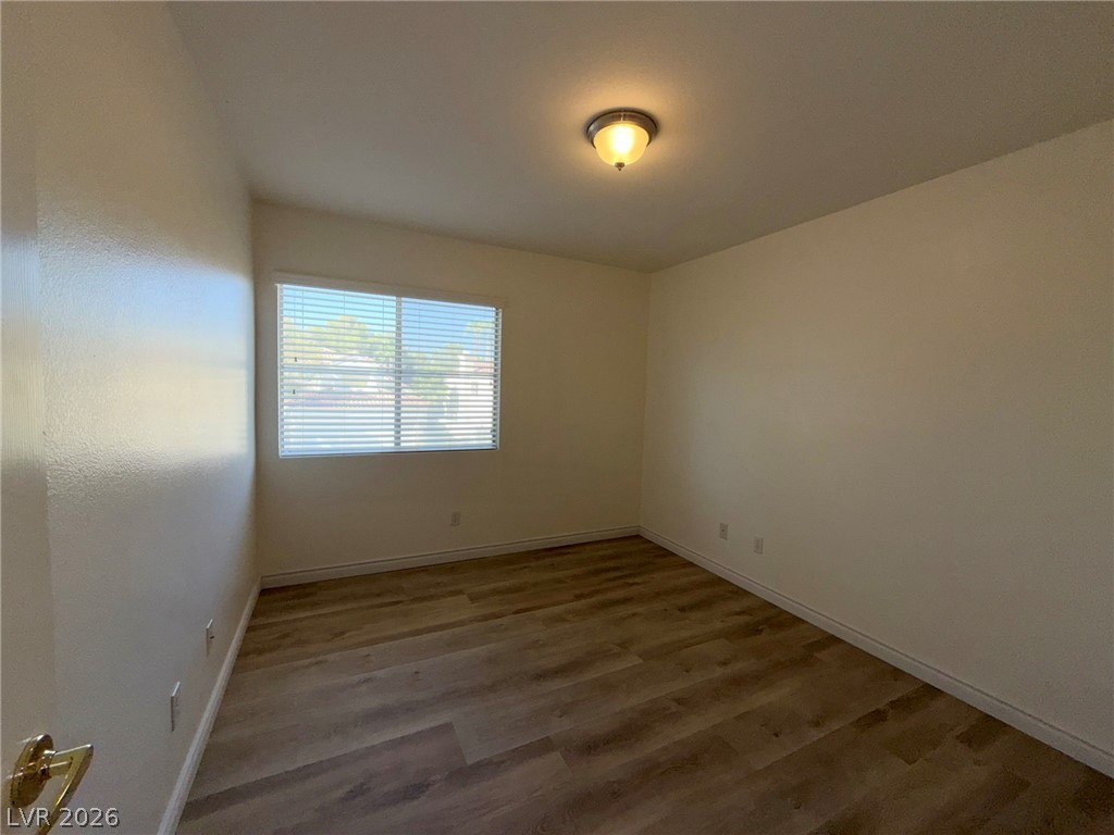 9729 Trail Rider Drive Las Vegas, NV 89117 - Photo 18 of 26 A well-lit bedroom features durable laminate flooring and ample natural illumination from a large window.