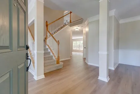 a view of entryway with wooden floor and stairs