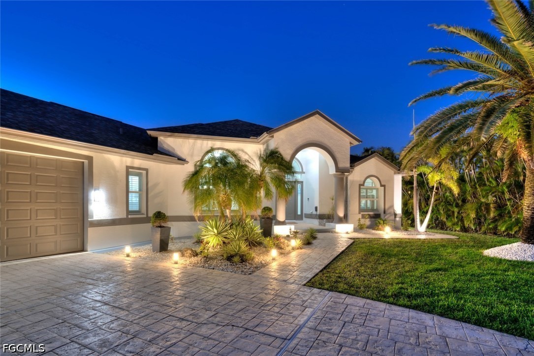 13570 Harbour Ridge Drive Fort Myers, FL 33908 - Photo 2 of 50 a front view of a house with a yard