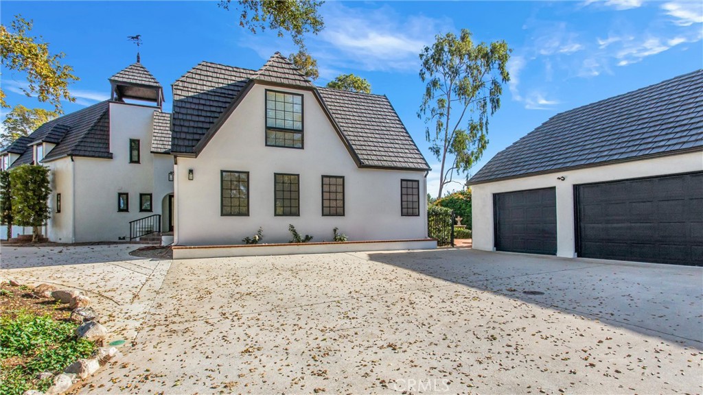 745 West Sunset Drive Redlands, CA 92373 - Photo 6 of 34 a front view of a house with a yard and garage