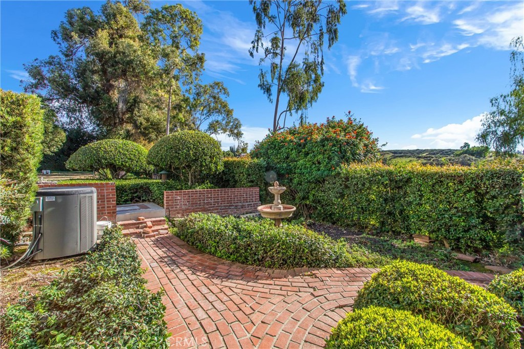 745 West Sunset Drive Redlands, CA 92373 - Photo 8 of 34 a view of a garden with a bench