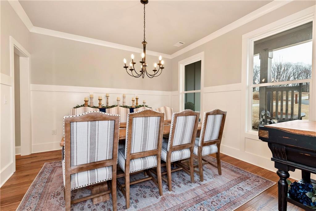 6140 Crescent Moon Ridge Cumming, GA 30041 - Photo 12 of 54 a view of a dining room with furniture window and wooden floor