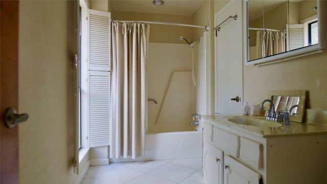 a bedroom with a bed and large window