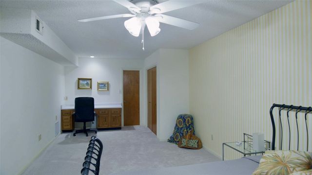 a bathroom with a granite countertop sink and a toilet