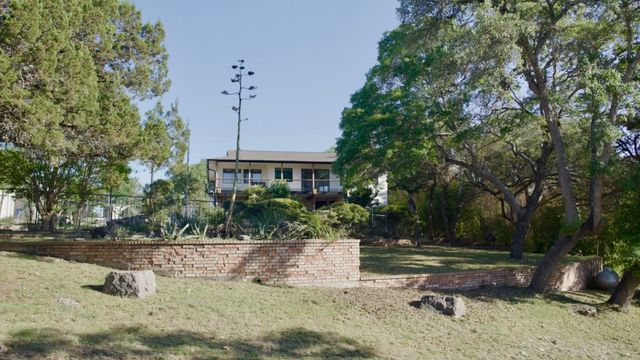 a view of a backyard with plants and a patio