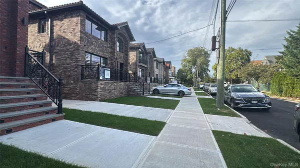a view of a brick house with a yard