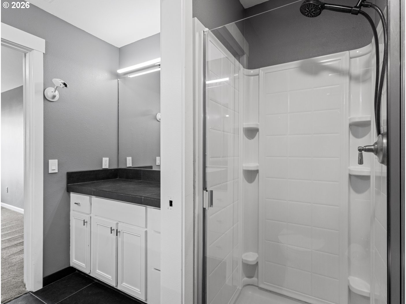 1952 Northeast 48th Way Hillsboro, OR 97124 - Photo 25 of 43 a bathroom with a granite countertop sink a mirror and shower