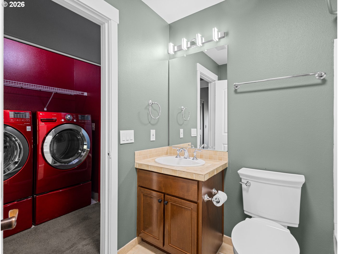 1952 Northeast 48th Way Hillsboro, OR 97124 - Photo 33 of 43 a bathroom with a toilet a sink a mirror and vanity