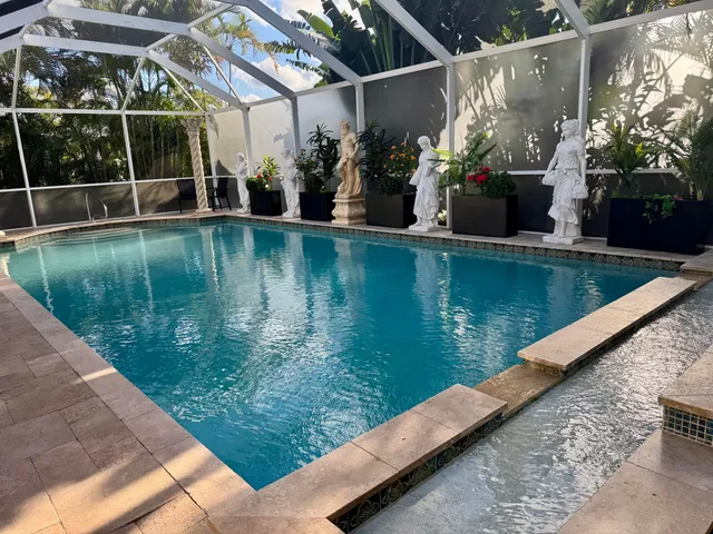 a kitchen with stainless steel appliances kitchen island granite countertop a sink and cabinets