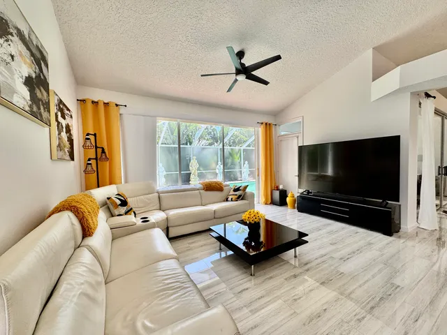 a bedroom with a balcony a bed and a flat screen tv