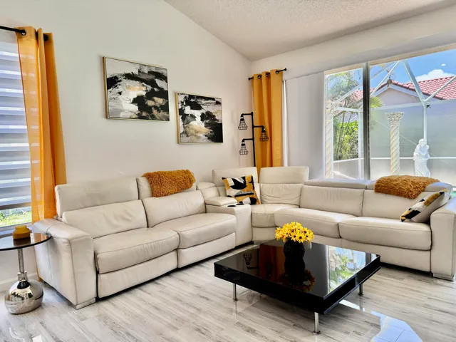 a spacious bedroom with a bed and a chandelier