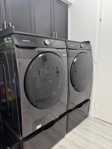 a bedroom with a large bed and a flat tv screen on dresser
