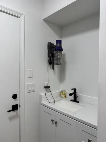 a spacious bathroom with a double vanity sink and a mirror