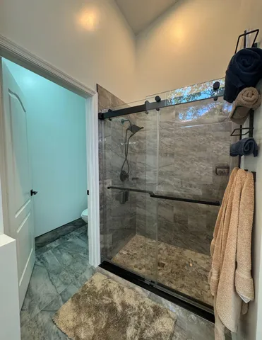 a bed room with a bed and a chair