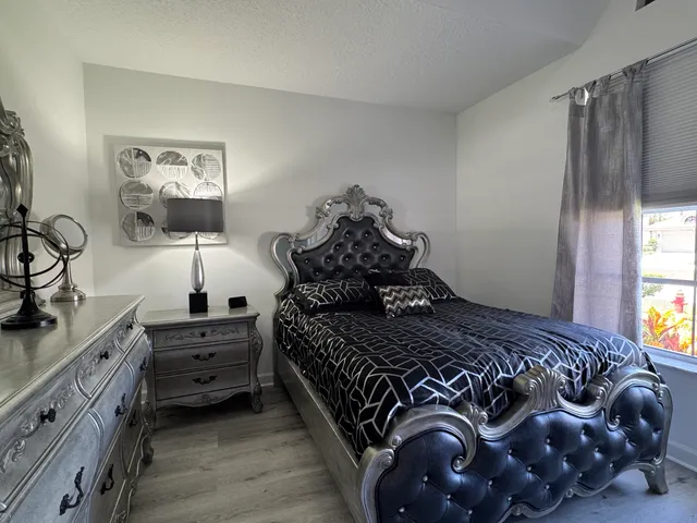 a view of a house with pool yard and sitting area