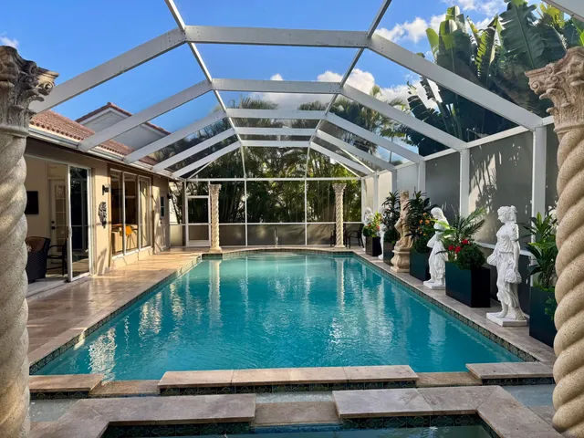 a view of swimming pool with a table and chairs