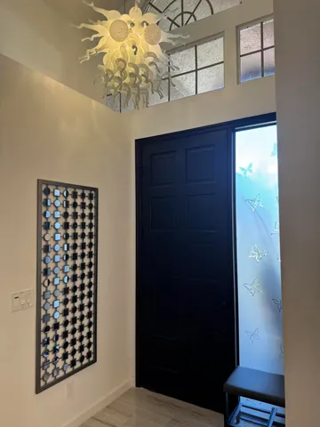 a living room with furniture a fireplace and a chandelier