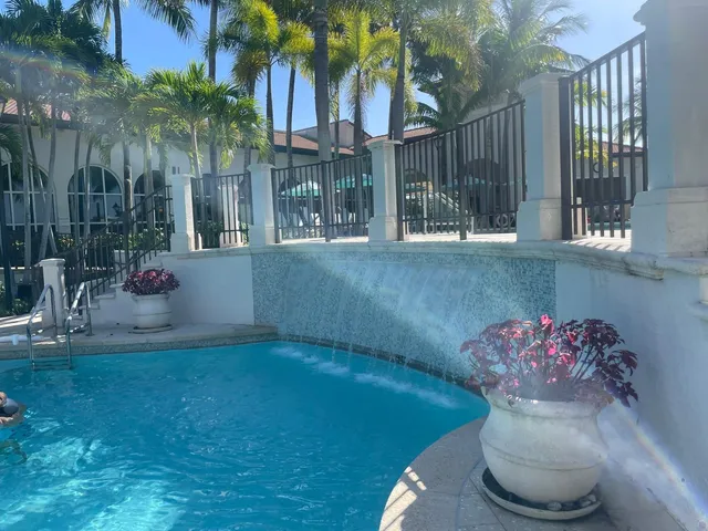 a living room with furniture a flat screen tv and kitchen view
