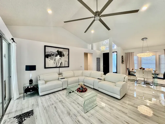 a kitchen with stainless steel appliances a stove a sink cabinets and a dining table