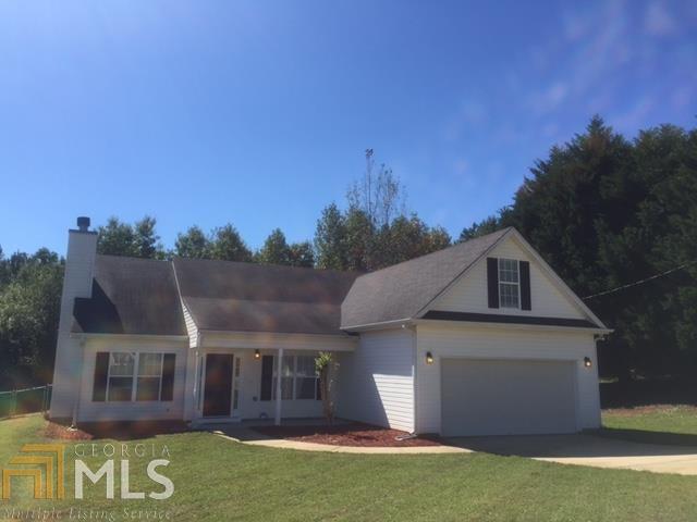 30 Spring Valley Trace Covington, GA 30016 - Photo 1 of 1 a front view of a house with a yard and garage