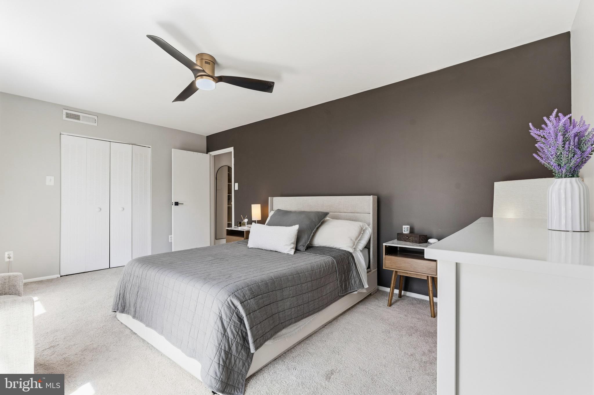 2032 Royal Fern Court, Unit 13/21A Reston, VA 20191 - Photo 21 of 28 a bedroom with a bed and a ceiling fan