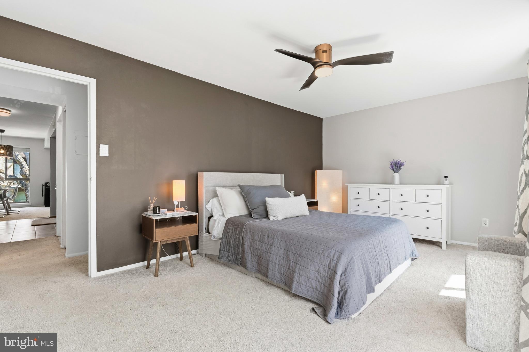 2032 Royal Fern Court, Unit 13/21A Reston, VA 20191 - Photo 22 of 28 a bedroom with a bed and a chandelier
