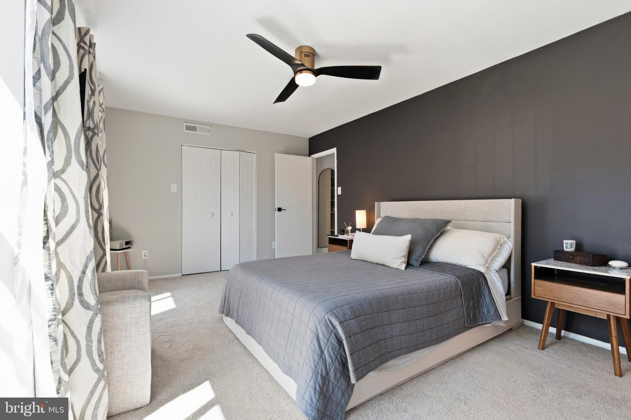 2032 Royal Fern Court, Unit 13/21A Reston, VA 20191 - Photo 24 of 28 a bedroom with a bed and a chandelier