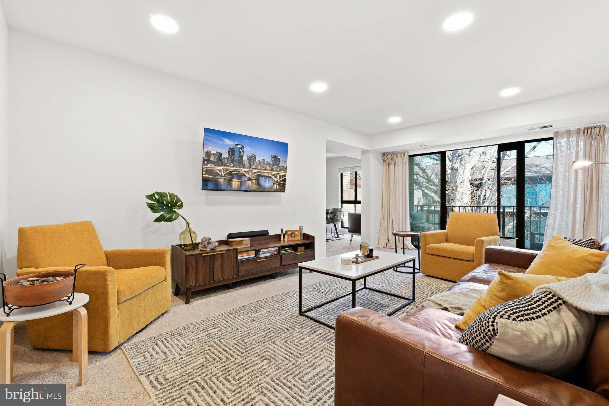 2032 Royal Fern Court, Unit 13/21A Reston, VA 20191 - Photo 6 of 28 a living room with furniture and a rug