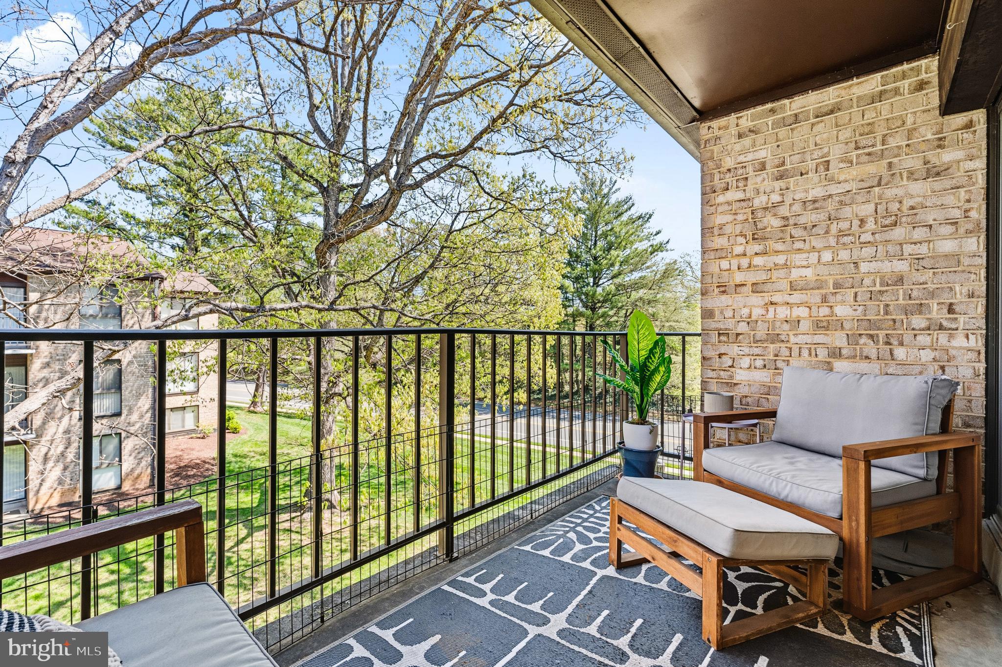 2032 Royal Fern Court, Unit 13/21A Reston, VA 20191 - Photo 10 of 28 a view of a balcony with wooden floor and outdoor seating