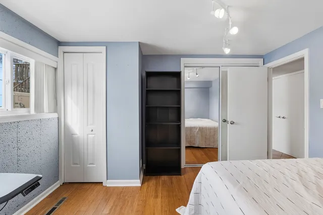 a bedroom with a bed and a dresser