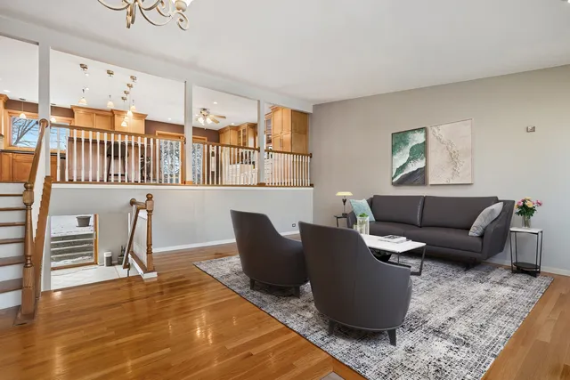 a living room with furniture a rug and a window
