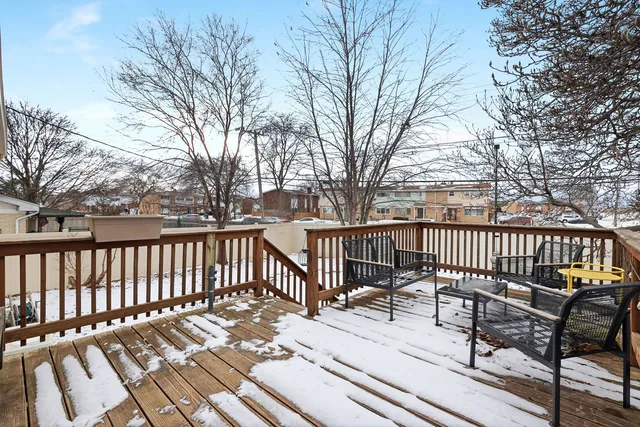 a view of a wooden deck with chairs